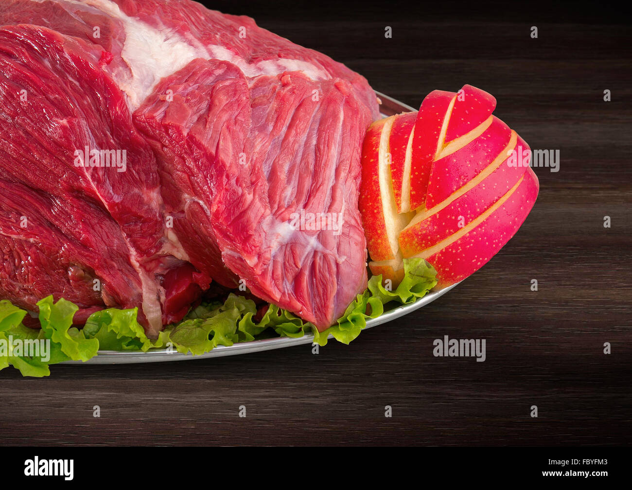 Detail of decorated fresh raw meat - ham with vegetables with clipping path Stock Photo