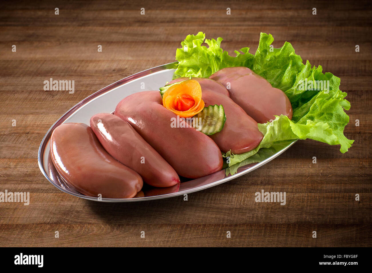 Kidney fresh and raw decorated with vegetables with clipping path Stock Photo