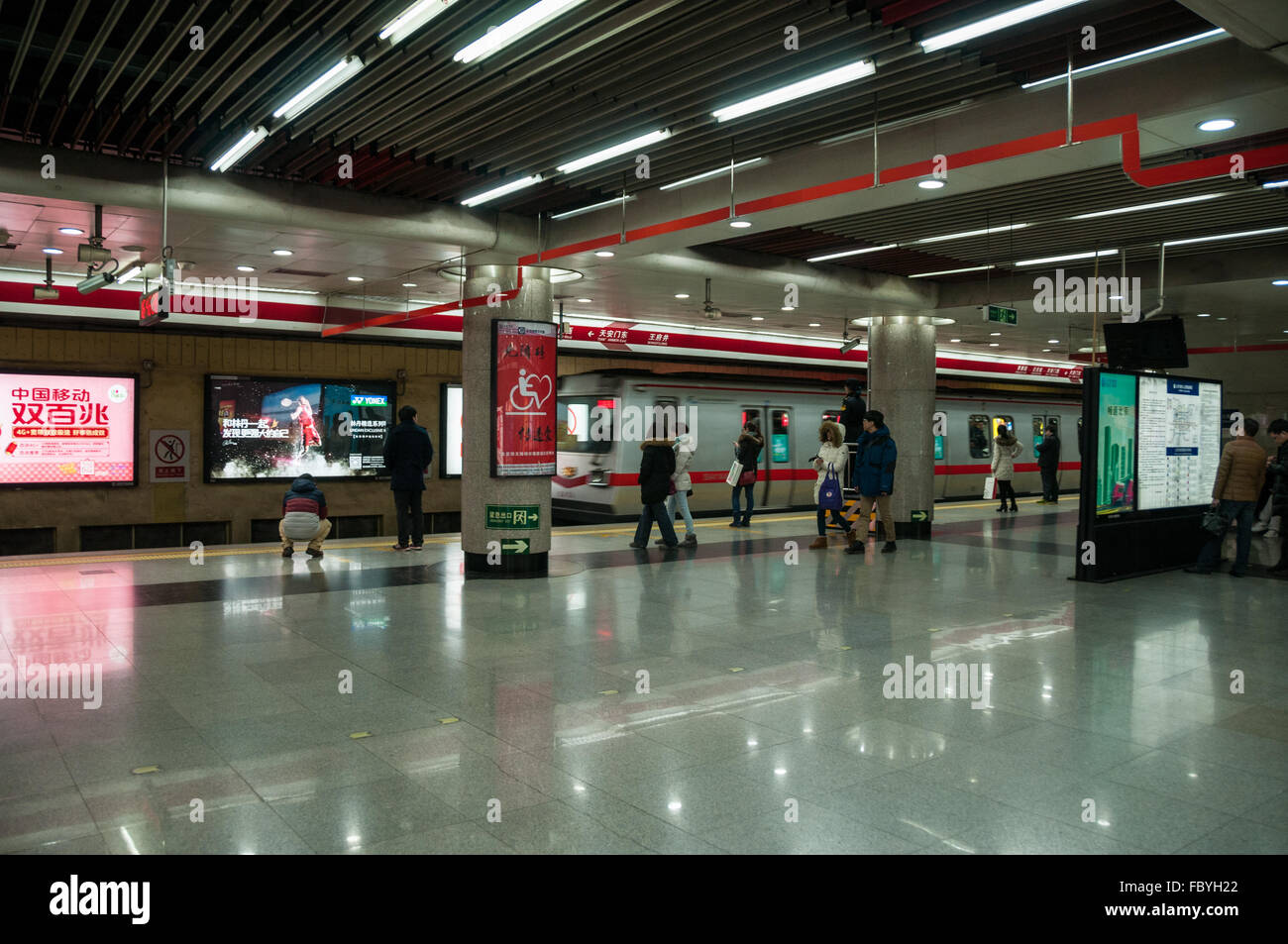 Students play online games inside a subway train in Beijing