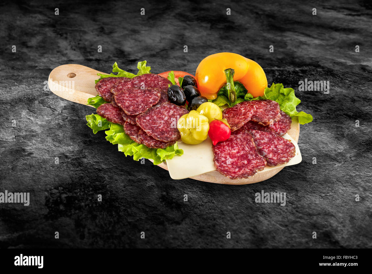 Salami sausage slice and vegetables on wooden board with clipping path Stock Photo