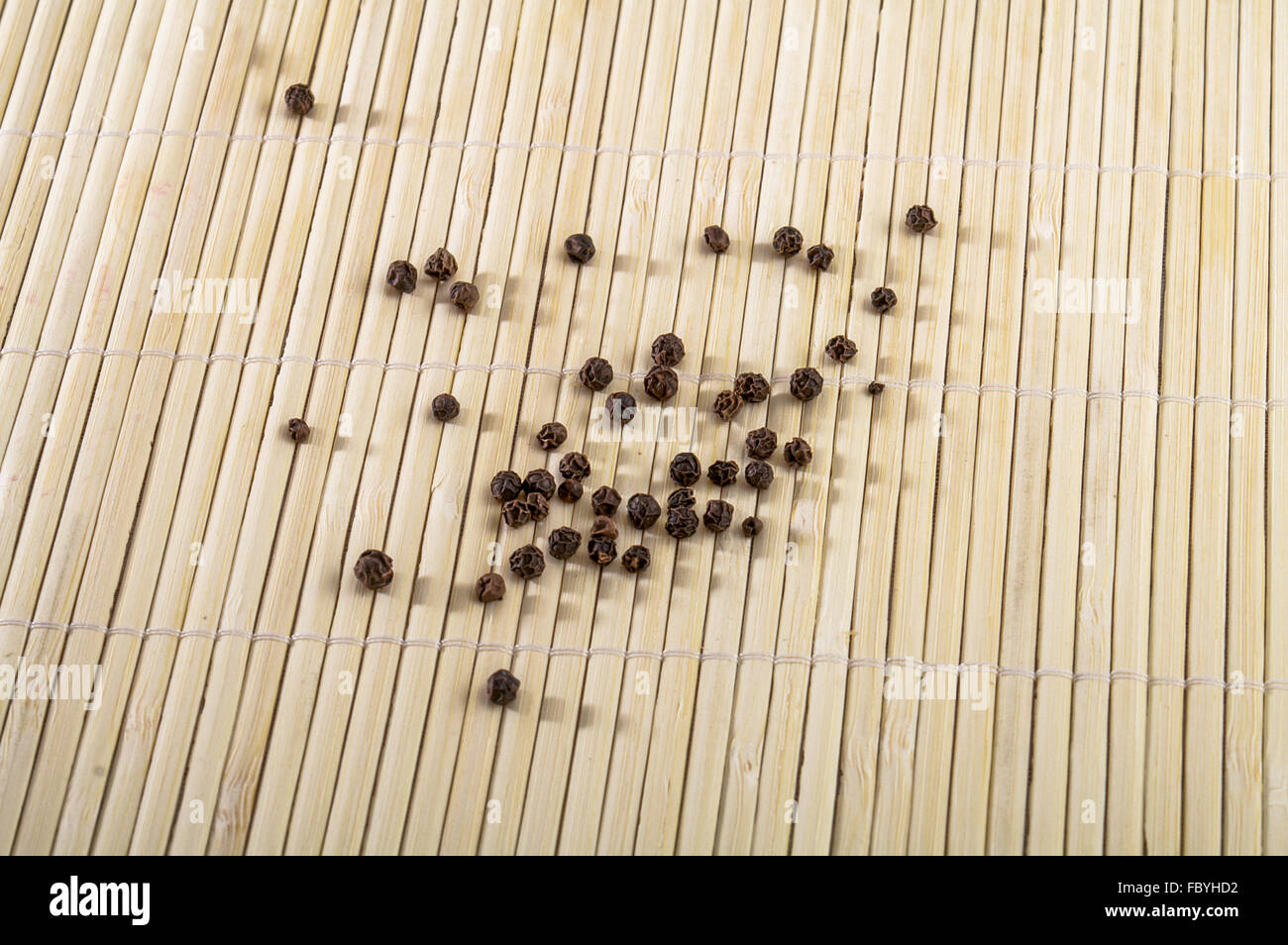Black pepper on bamboo backround - texture Stock Photo