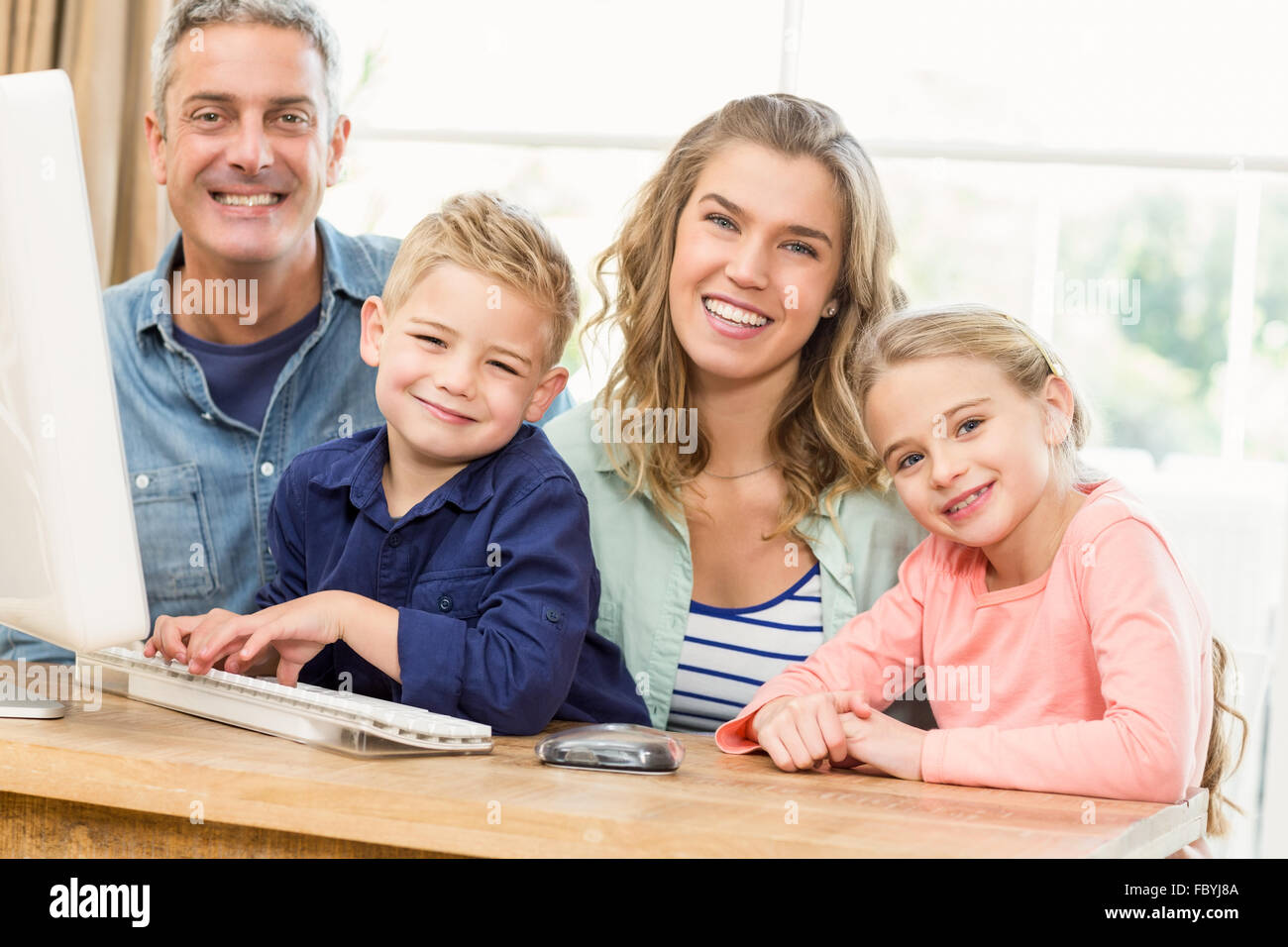 Happy family using the computer Stock Photo - Alamy
