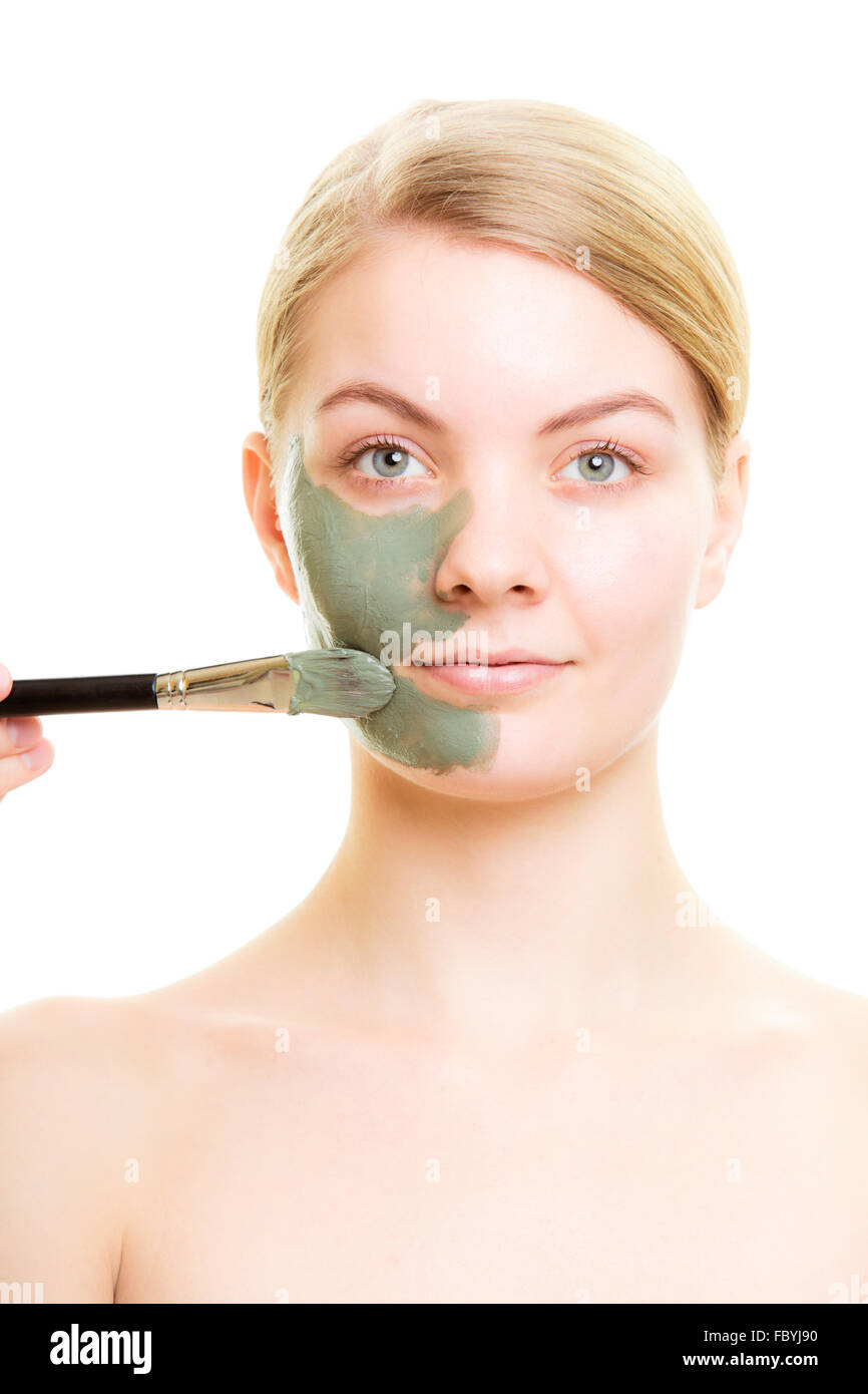 Skin care. Woman applying clay mud mask on face Stock Photo Alamy