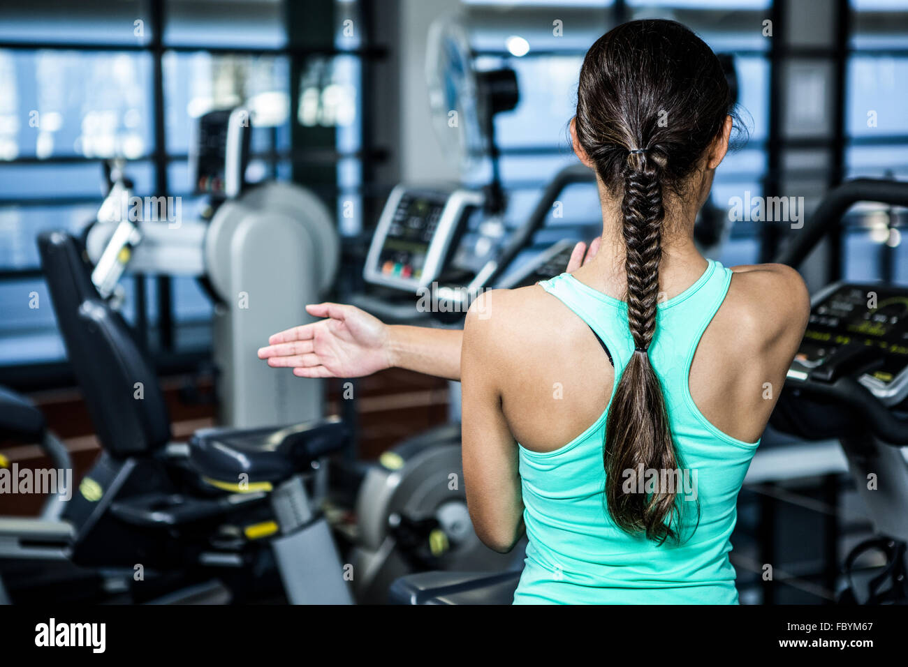 Rear view of woman stretching arms Stock Photo - Alamy