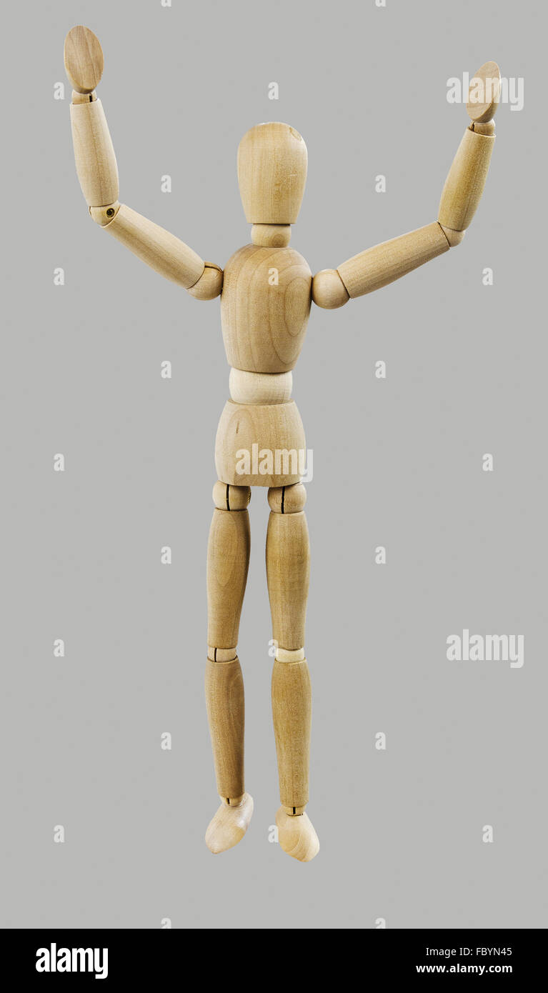 wooden Dutch doll with hands in the air Stock Photo