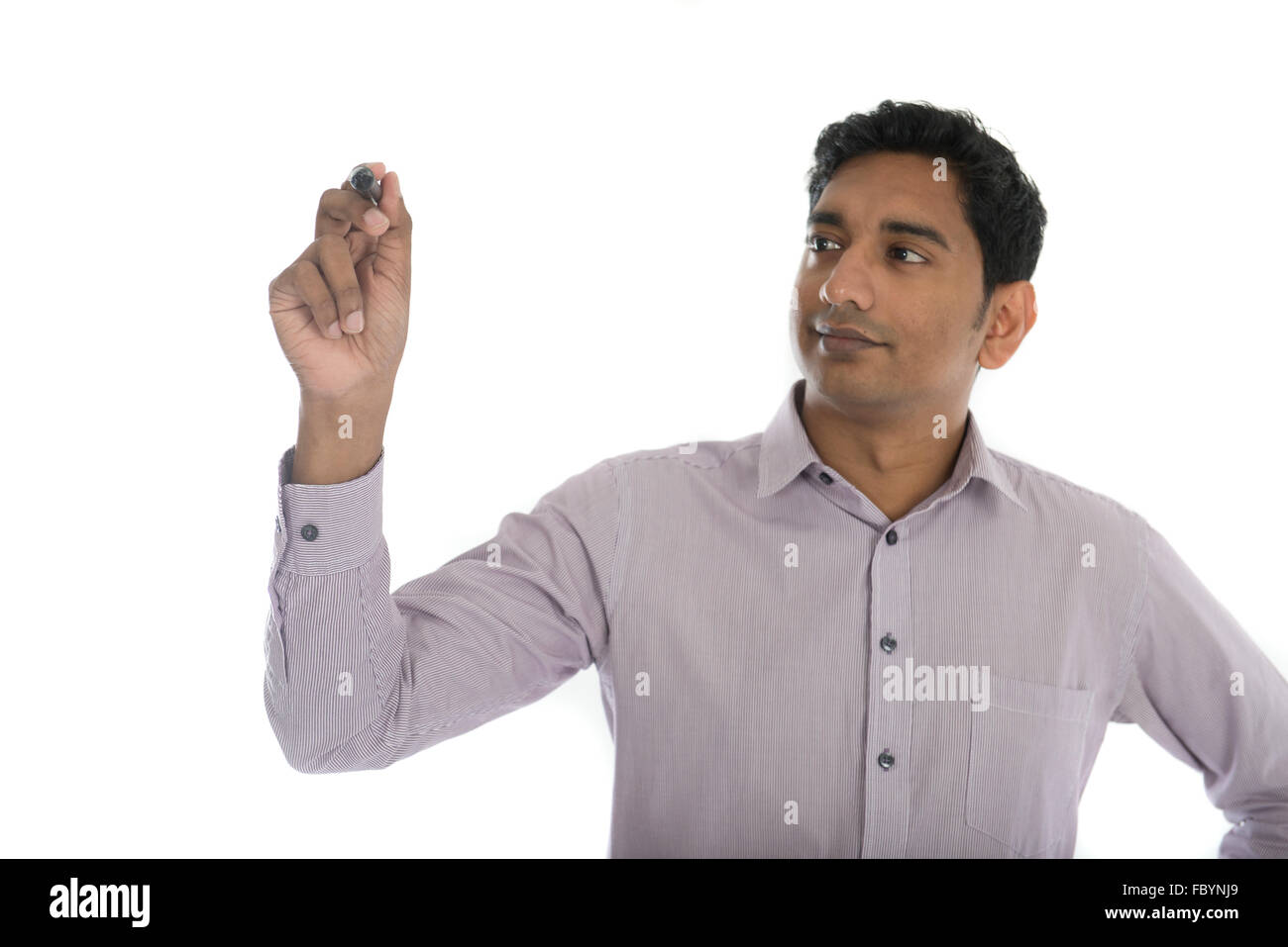 Asian Indian businessman in black suit writing something on glass board ...