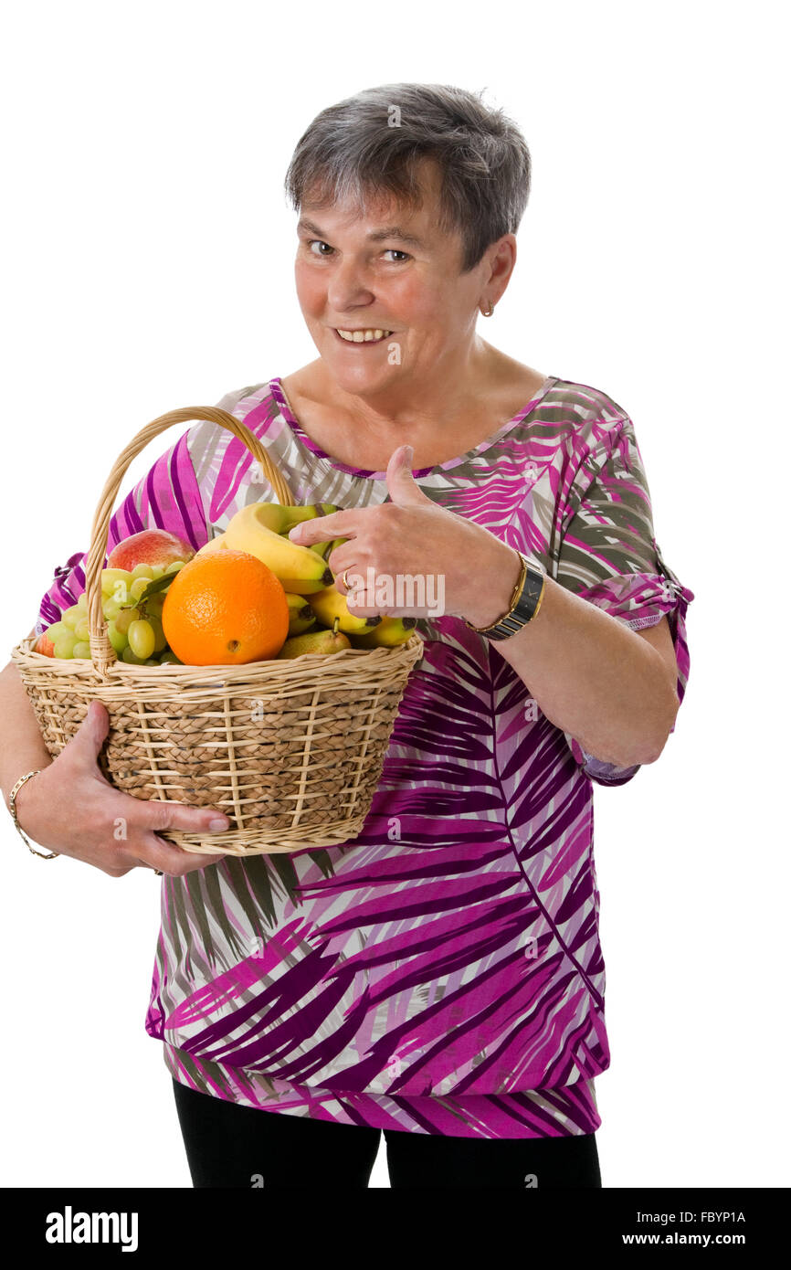 Senior woman presenting fruit Stock Photo - Alamy