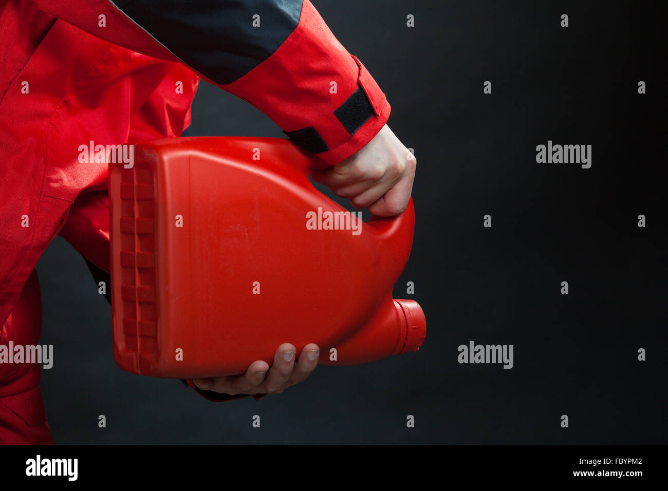 Worker of gas station with petrol canister oil can Stock Photo Alamy