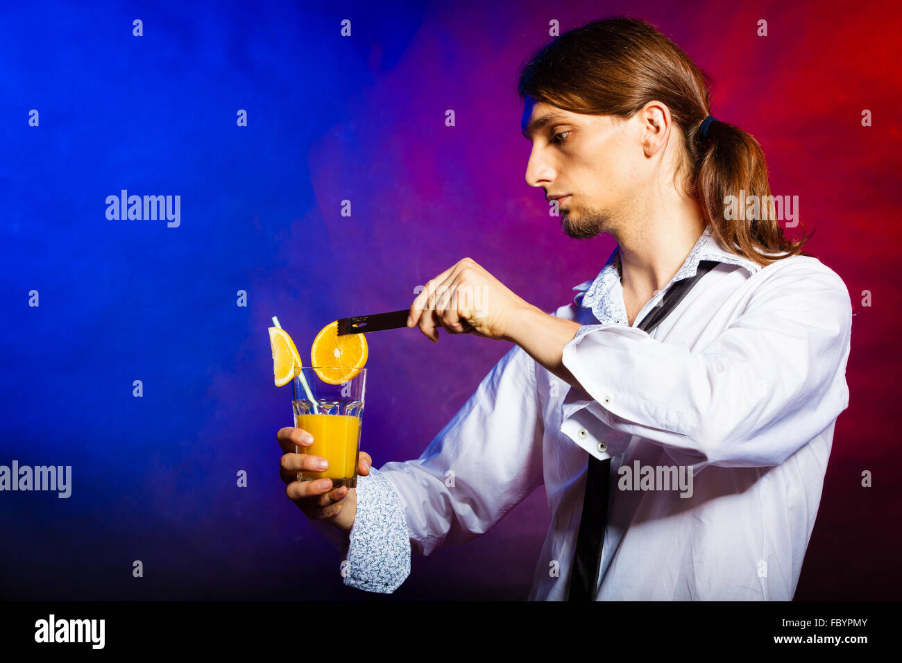 Young man bartender preparing alcohol cocktail drink Stock Photo