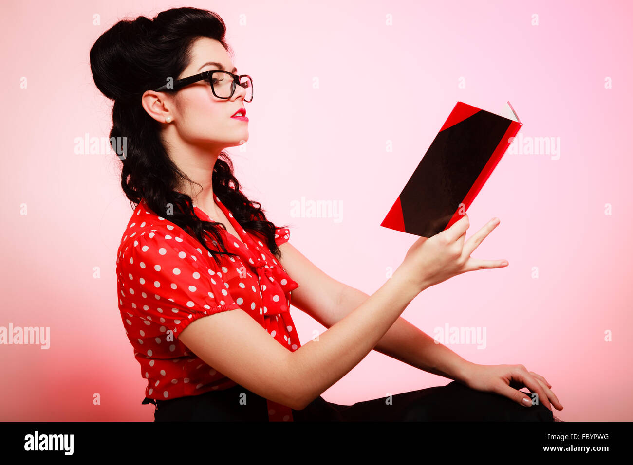 Retro. Pinup girl in eyeglasses reading book Stock Photo Alamy
