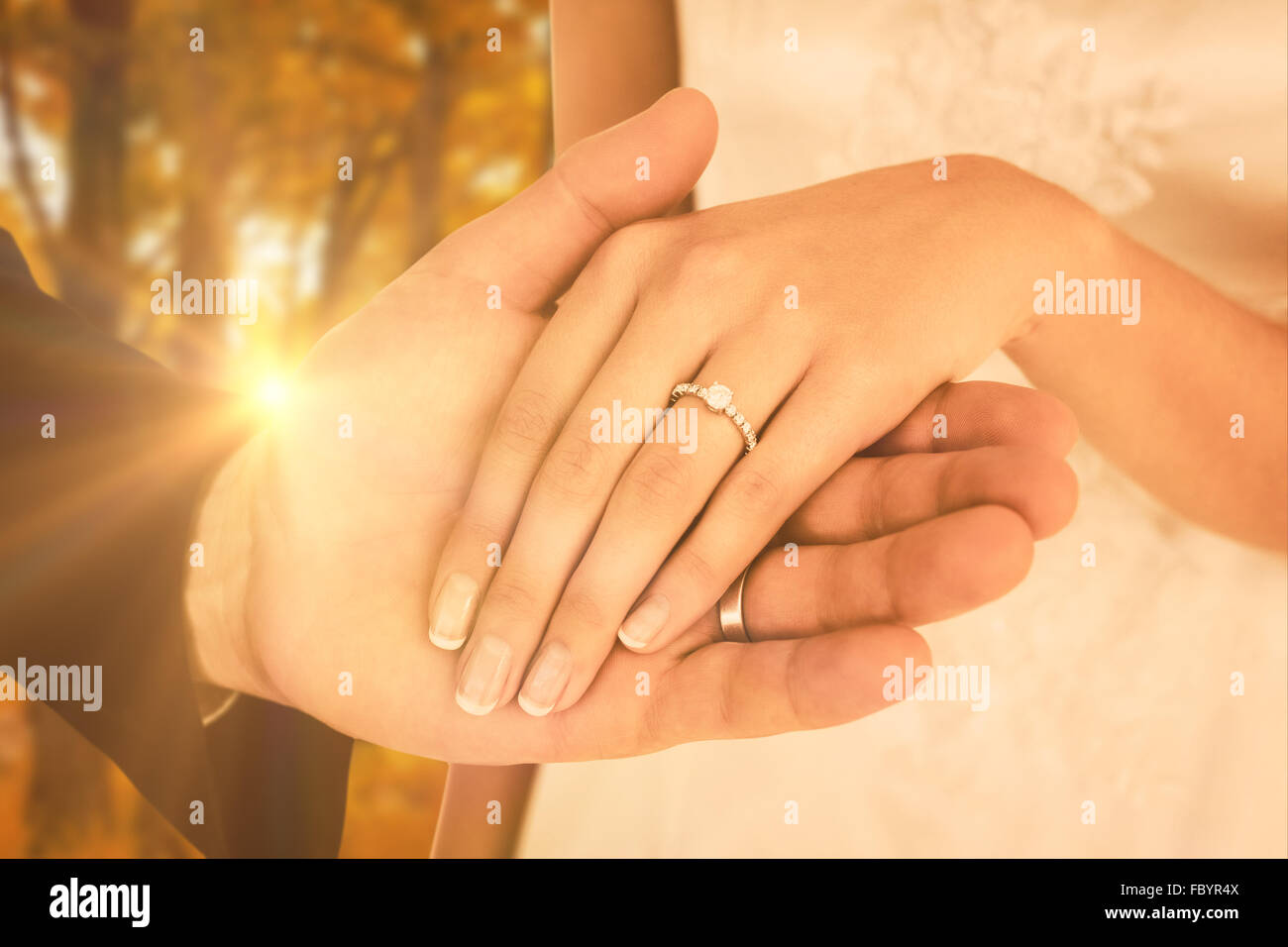 Composite image of cropped image of newly wed couple holding hands Stock Photo