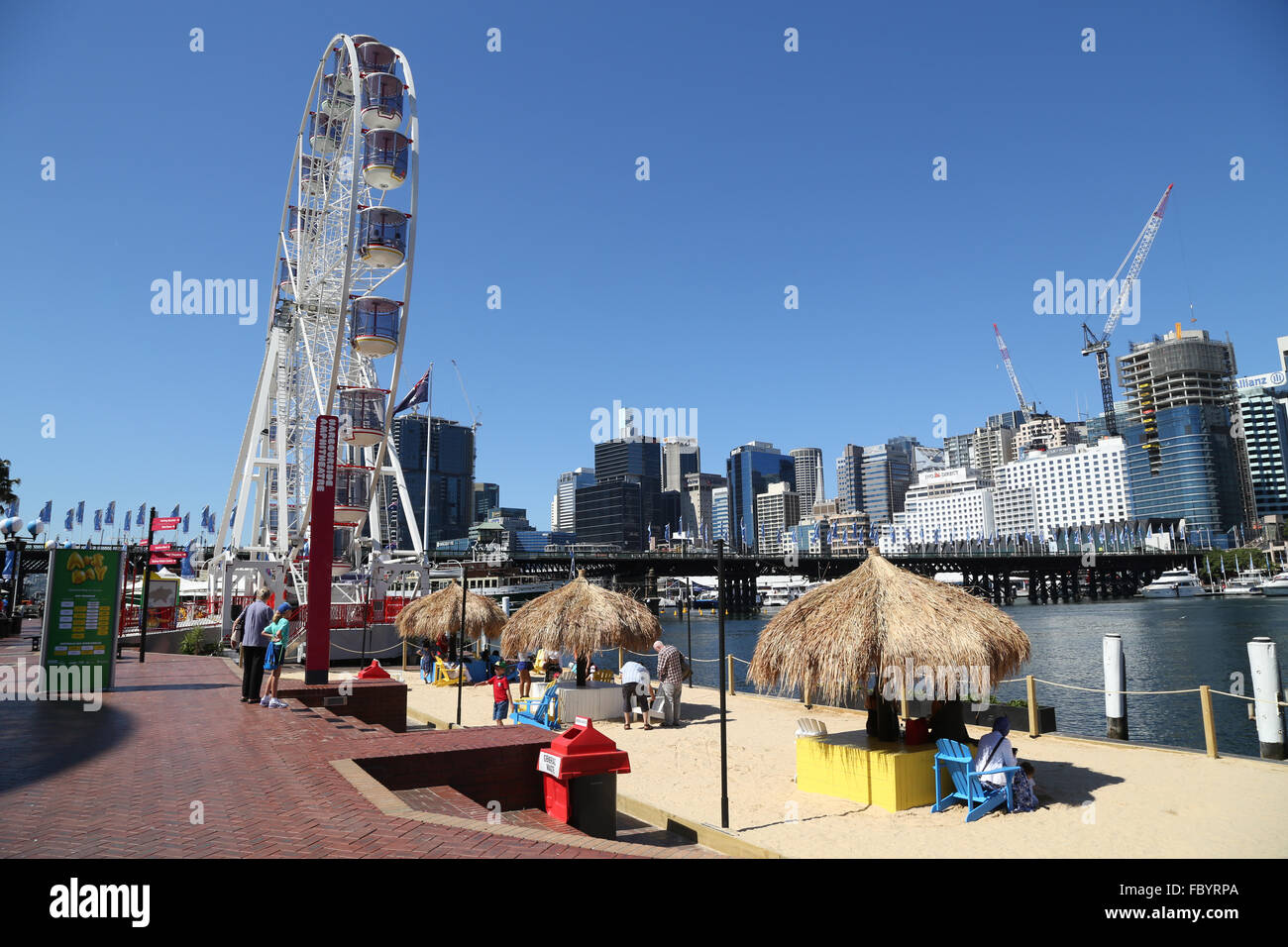 Star of the Show Ferris wheel and a synthetic beach at Darling Harbour, Sydney, Australia. Stock Photo