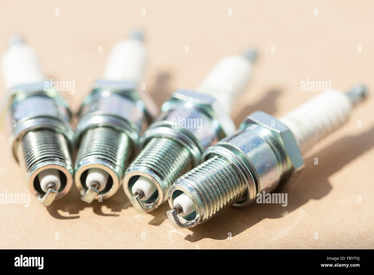 Auto service. Set of spark plugs as spare part of car. Stock Photo