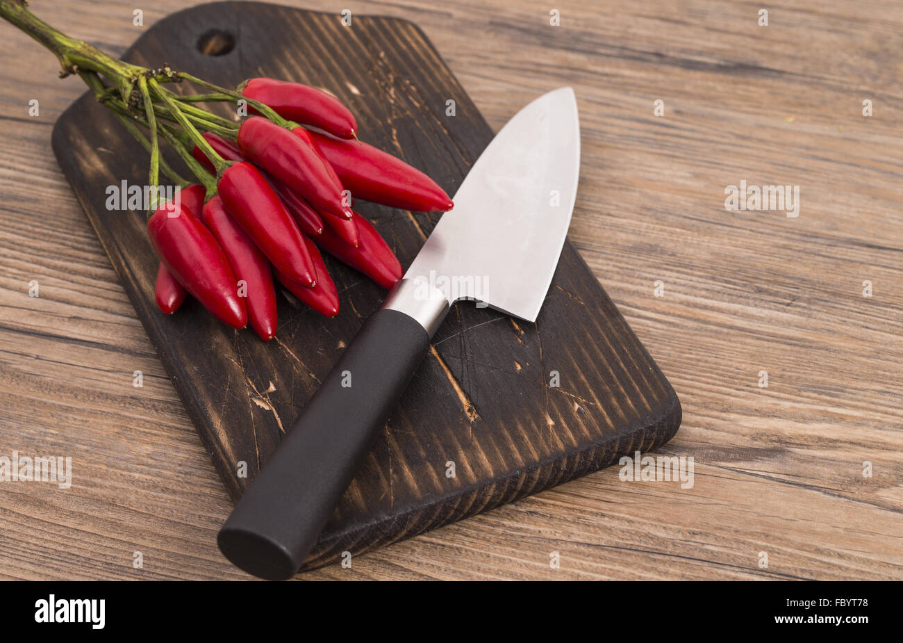 Red peppers with knife Stock Photo