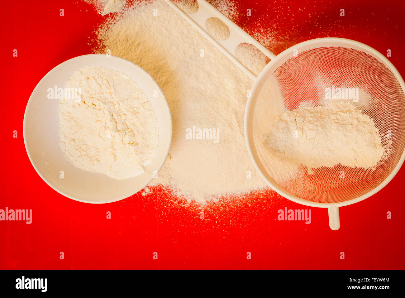 Preparation for baking, ingredients flour sifting Stock Photo Alamy
