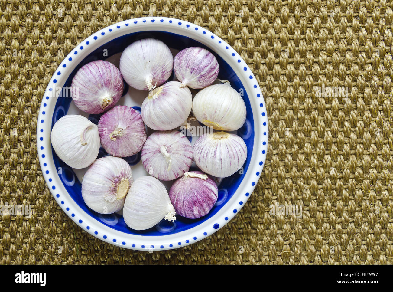 solo garlic in a porcelain bowl Stock Photo