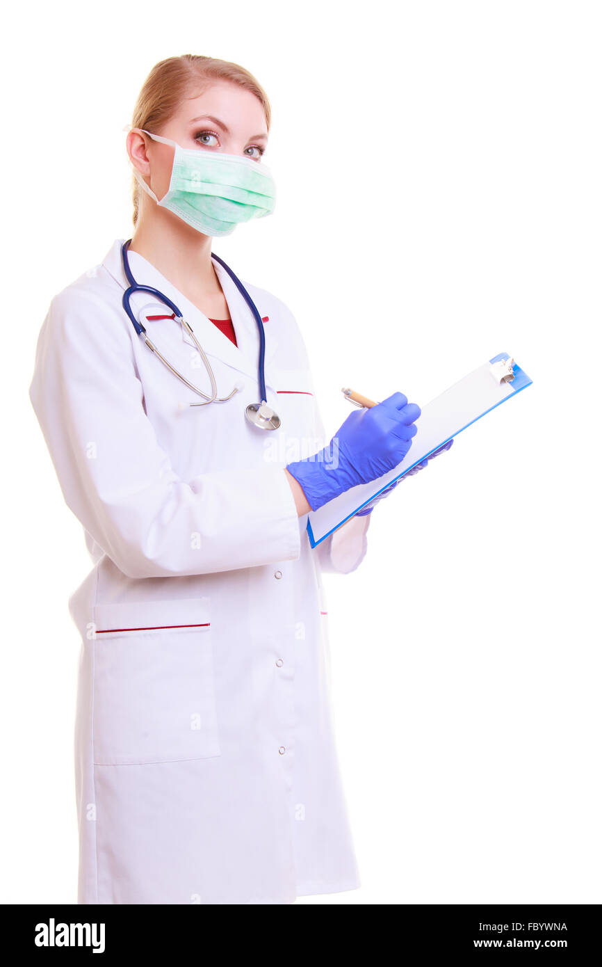 Woman in face mask and white lab coat. Doctor or nurse with stethoscope writing with pen on clipboard isolated. Medical person f Stock Photo