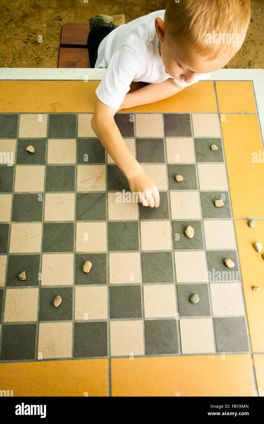 Child Playing Draughts Or Checkers Board Game Outdoor Stock Photo Alamy