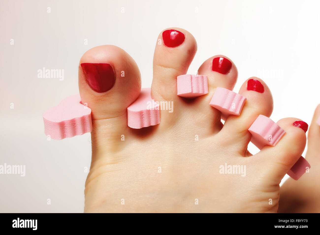foot pedicure applying red toenails Stock Photo Alamy