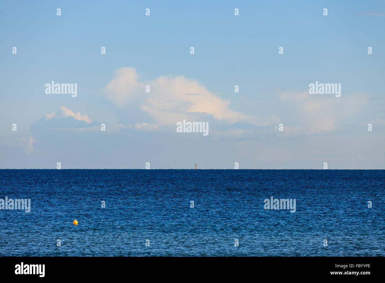 cloudy sky above blue surface of the sea Stock Photo - Alamy