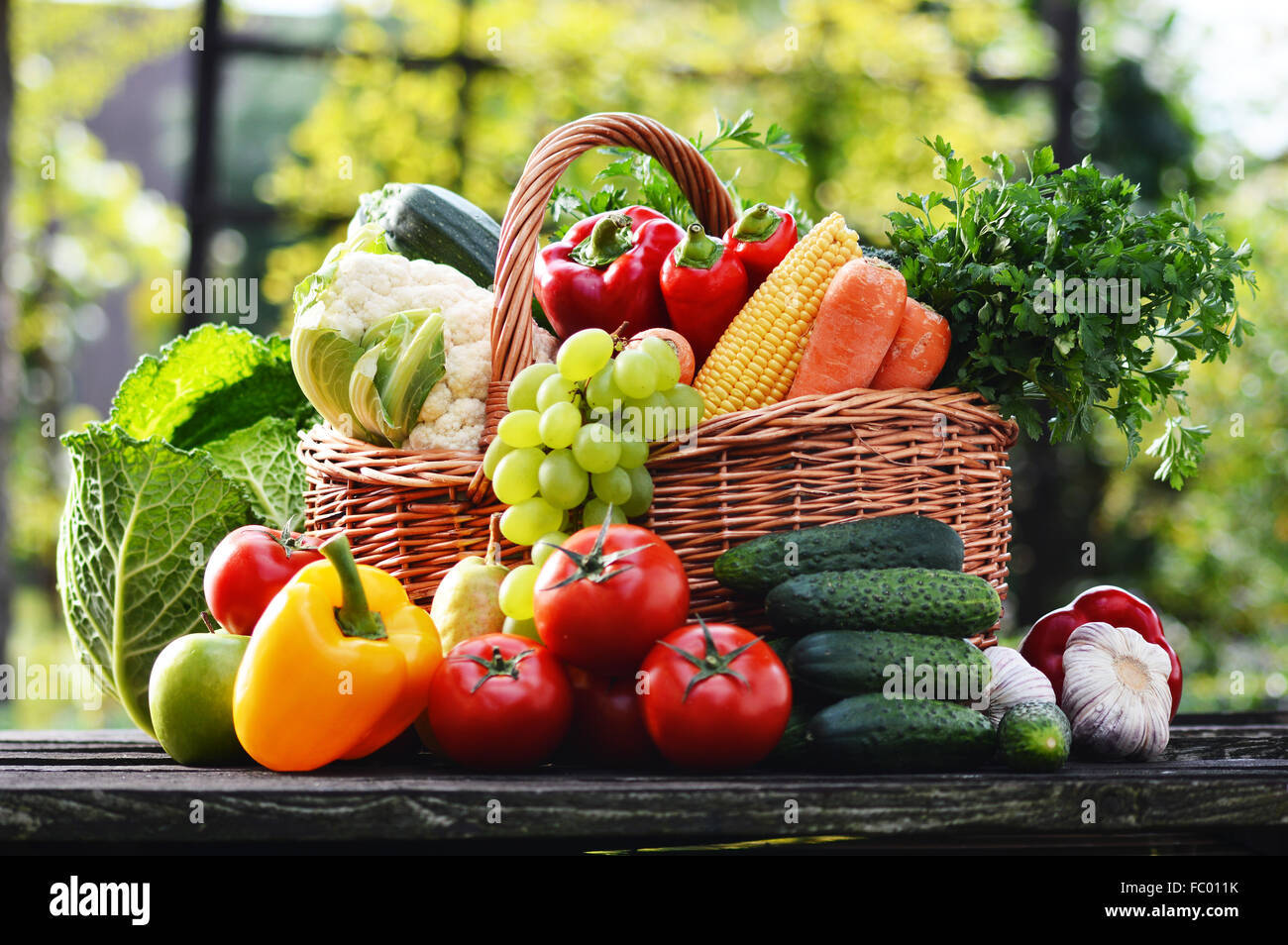 Wicker basket with assorted raw organic vegetables in the garden Stock ...