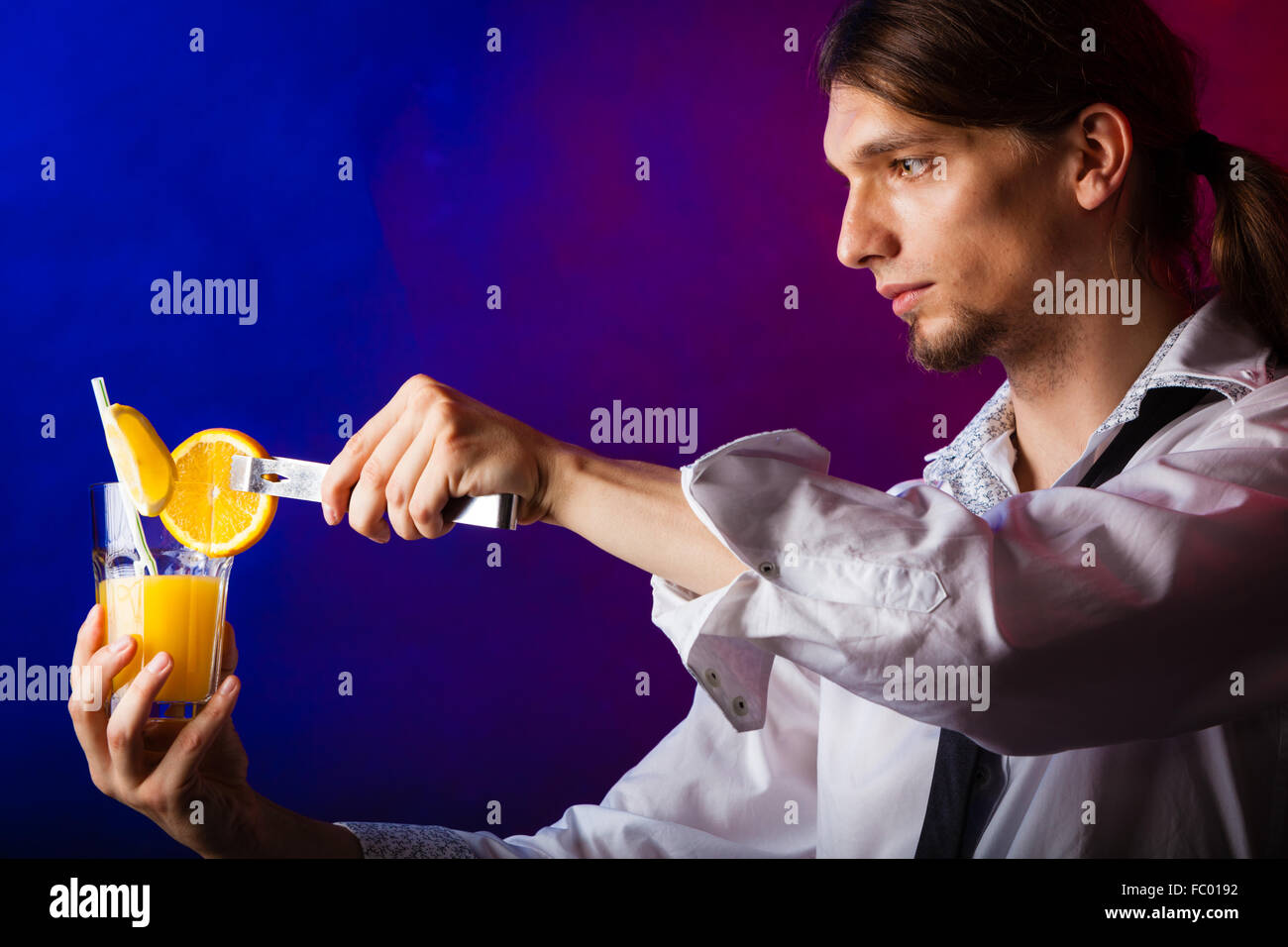 Young man bartender preparing alcohol cocktail drink Stock Photo