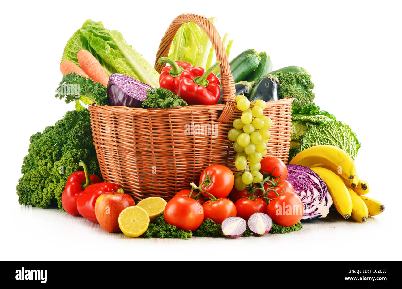 Wicker basket with assorted organic vegetables and fruits isolated on ...