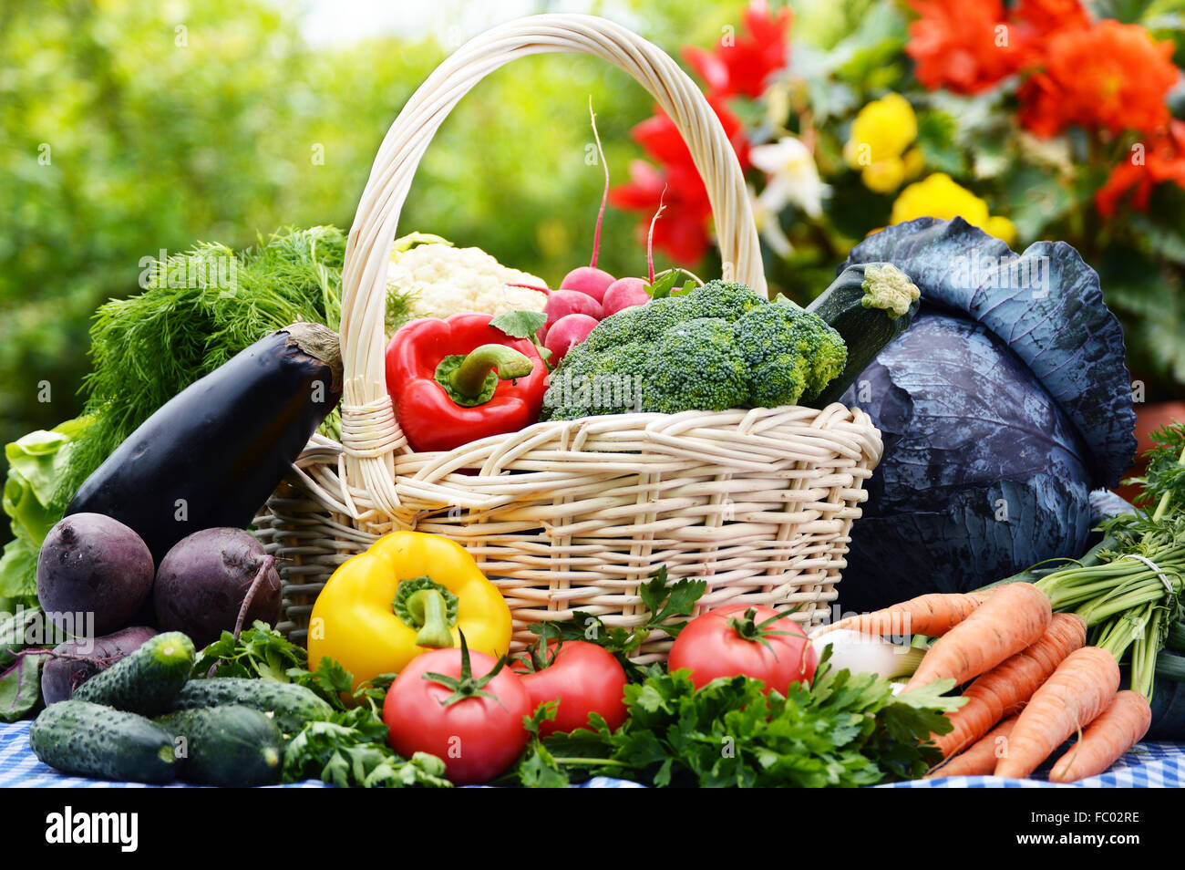 Assorted vegetables in wicker basket in the garden Stock Photo - Alamy