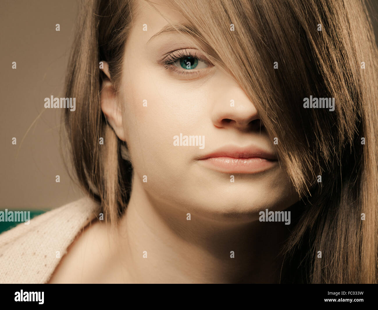 portrait of pretty girl with hair fringe covered eye Stock Photo