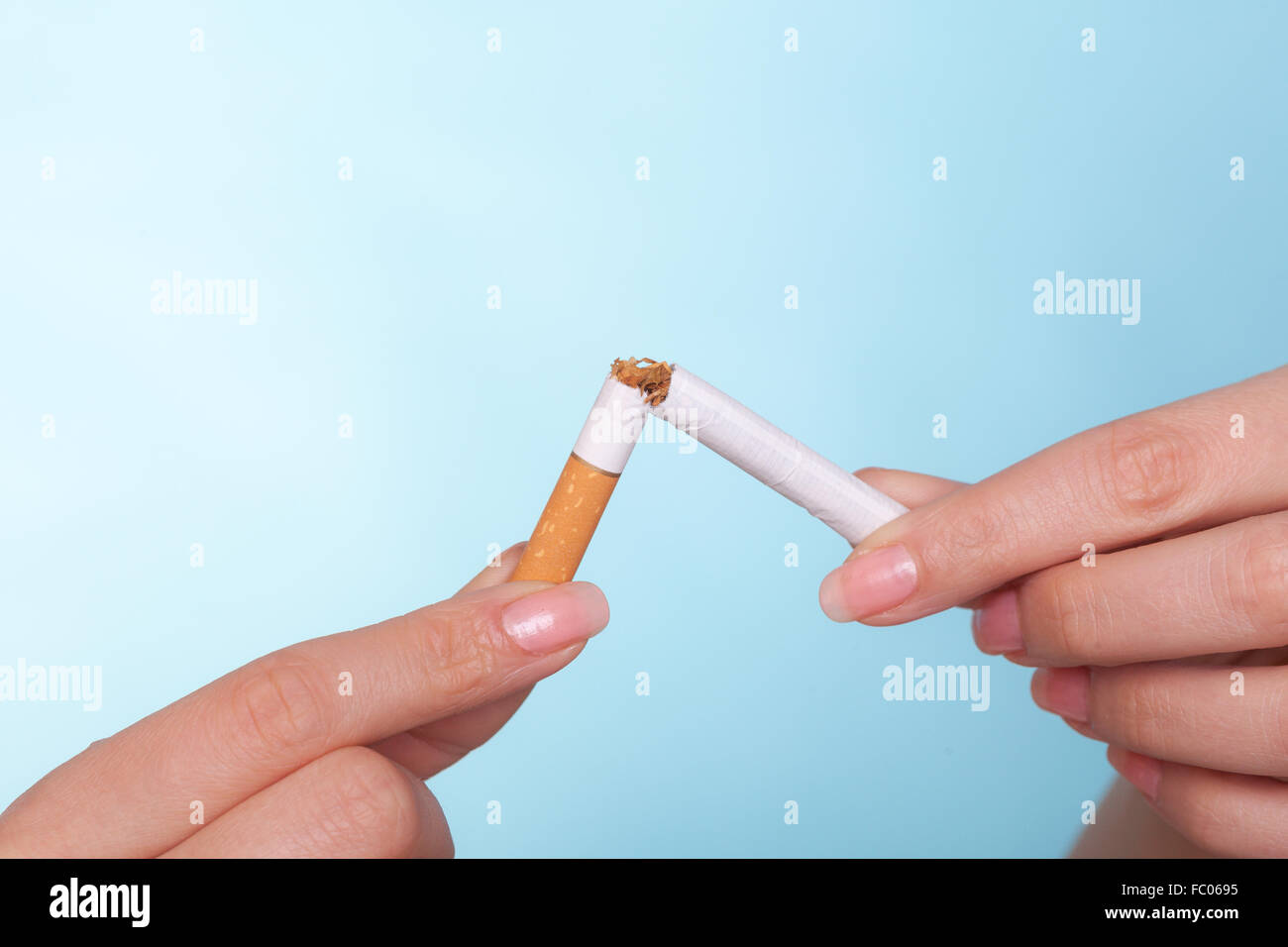 Addiction. Hands breaking cigarette. Quit smoking. Stock Photo