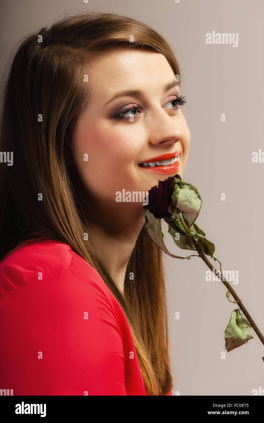 Fashion woman teen girl in red gown with dry rose Stock Photo Alamy