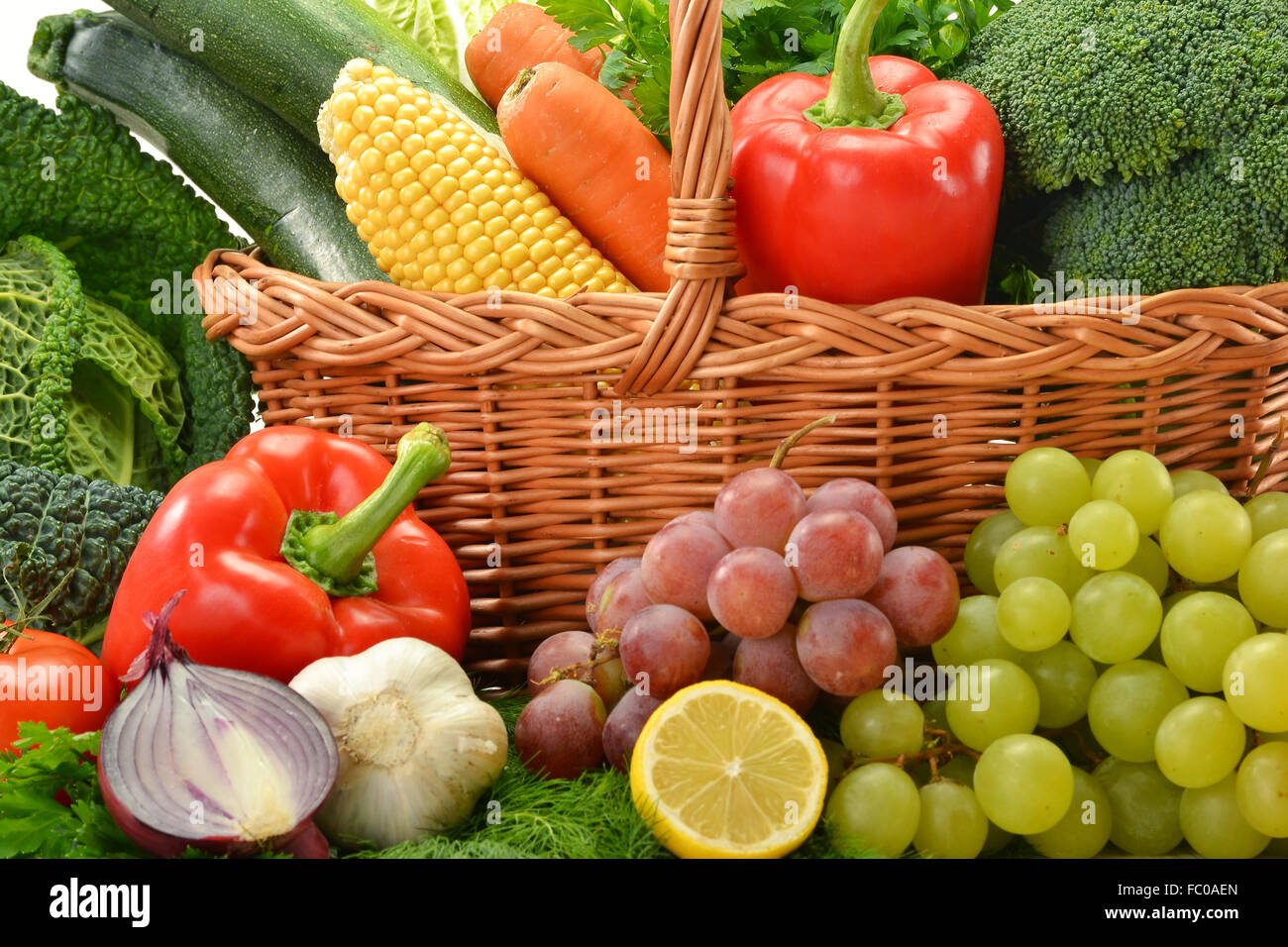 Composition with vegetables and fruits in wicker basket isolated Stock ...