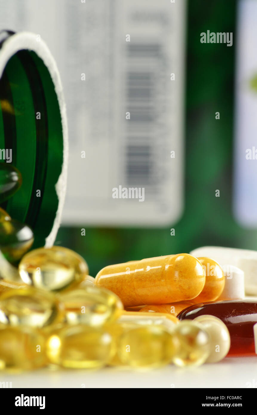 Composition with dietary supplement capsules and containers. Variety of drug pills Stock Photo