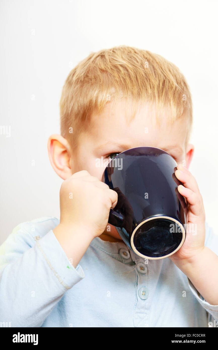 Funny little boy child drinking tea. Indoor Stock Photo Alamy