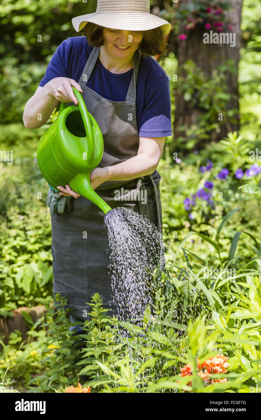 Woman watering flowers Stock Photo