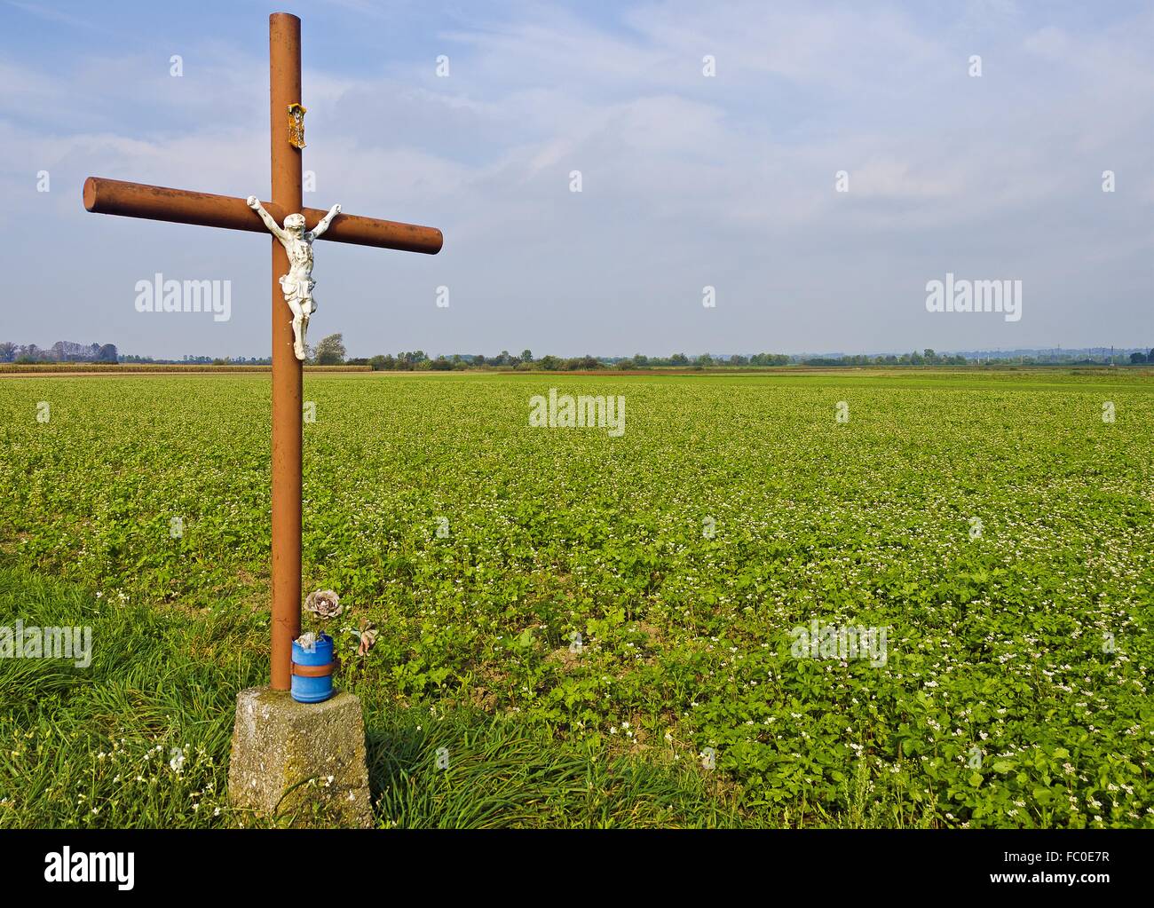 road cross with statue of Christ Stock Photo