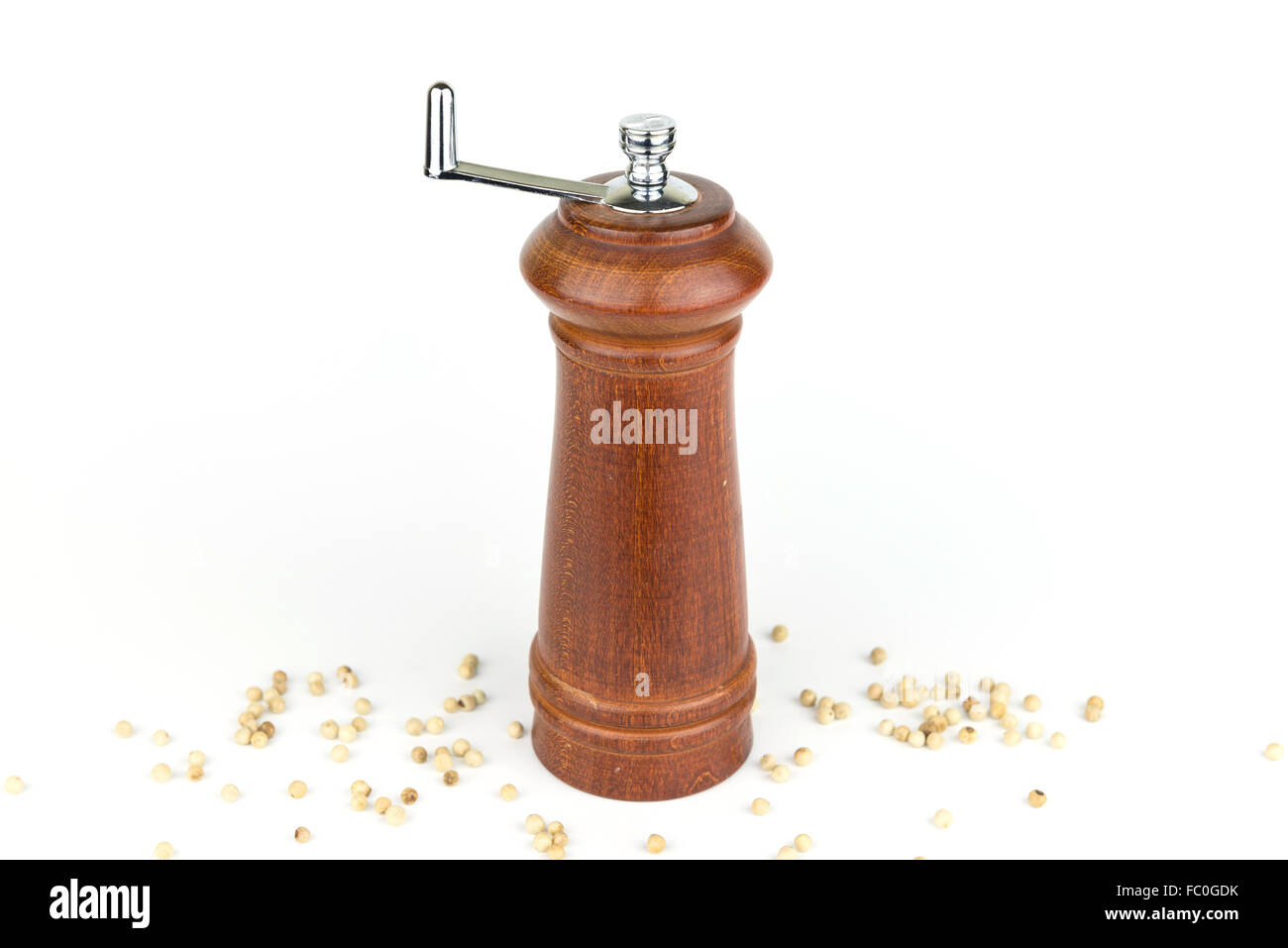 brown wooden pepper crusher spinner on isolate white background Stock Photo