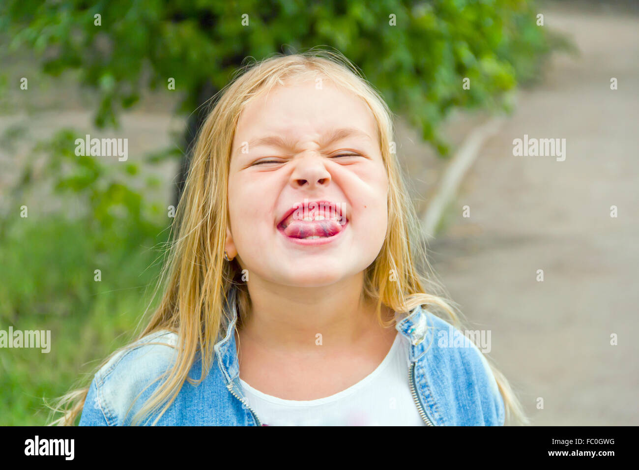 Girl makes faces imitate witch Stock Photo
