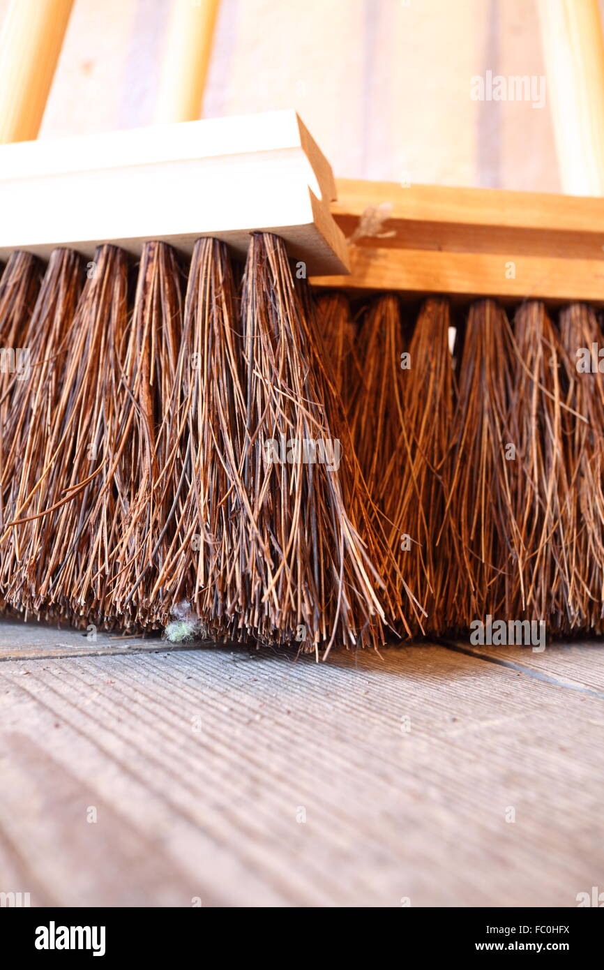 large brooms on wooden floor housework Stock Photo Alamy