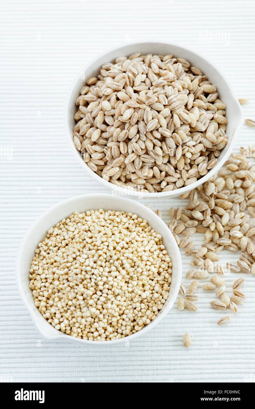 Quinoa. seeds of the quinoa (Chenopodium quinoa) herb plant. in a bowl and pearl barley Stock Photo