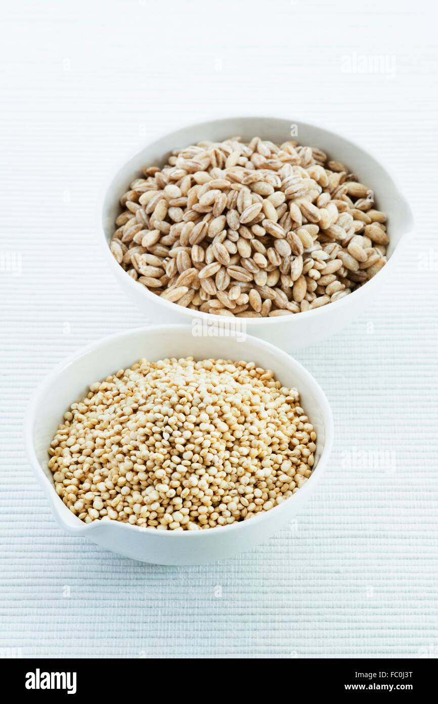 Quinoa. seeds of the quinoa (Chenopodium quinoa) herb plant. in a bowl and pearl barley Stock Photo