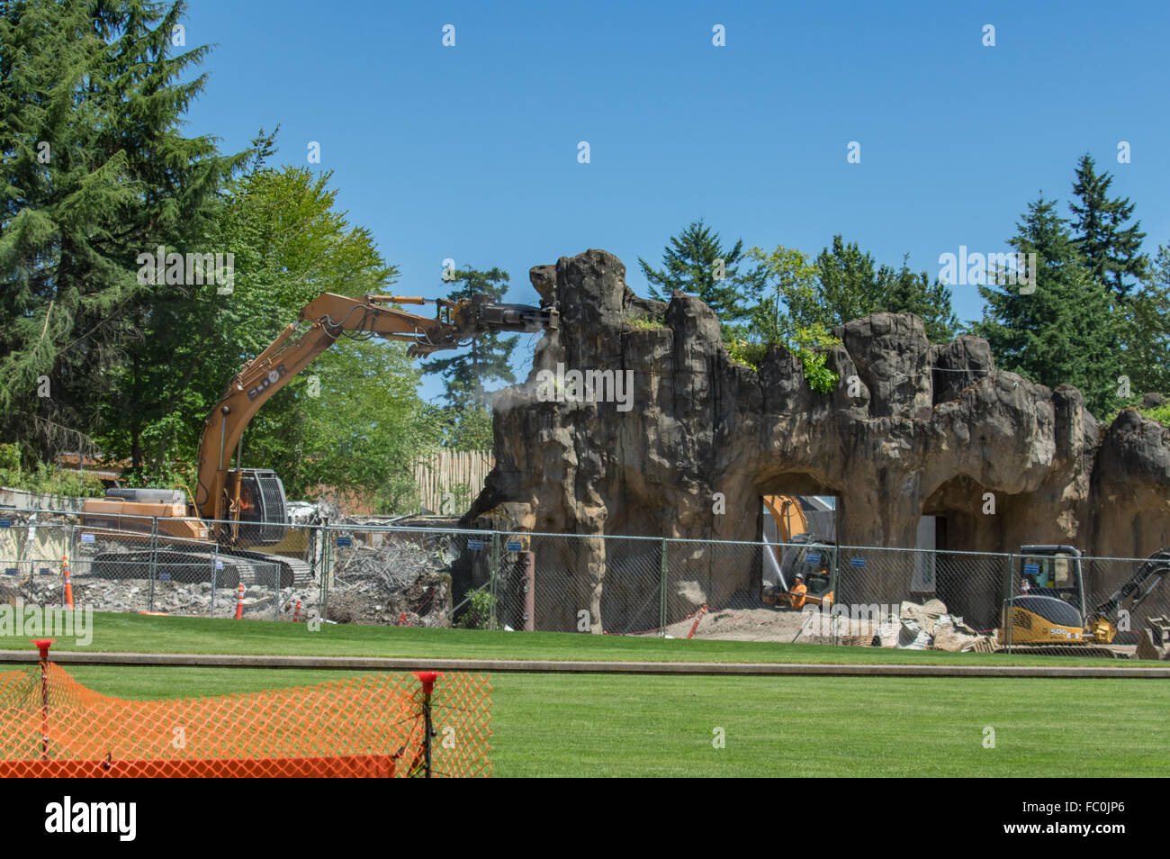 Heavy equipment using a jack hammer to demolish part of the exhibit at the Oregon Zoo.  Portland, Oregon, USA Stock Photo