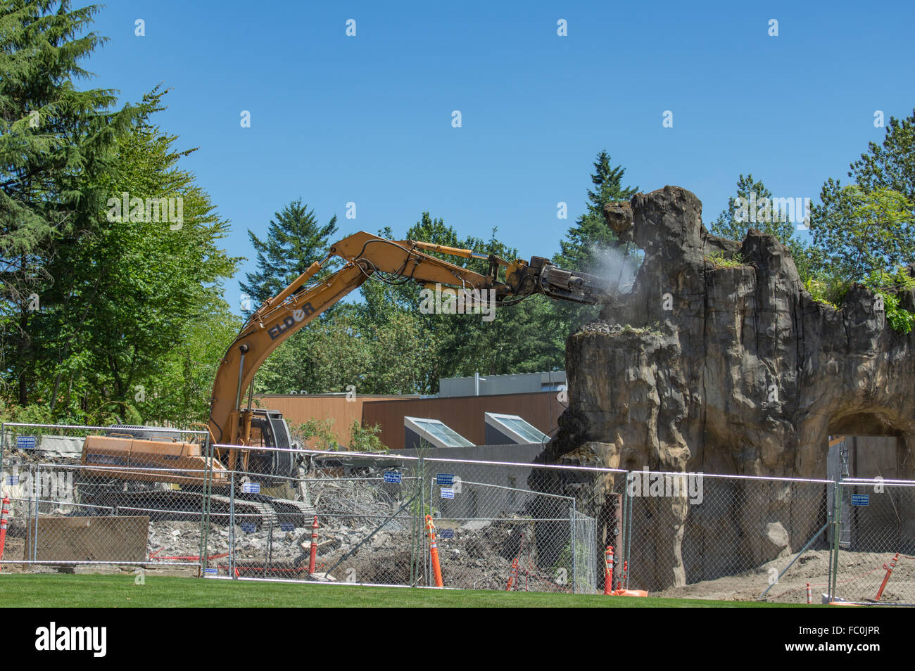 Heavy equipment using a jack hammer to demolish part of the exhibit at the Oregon Zoo.  Portland, Oregon, USA Stock Photo