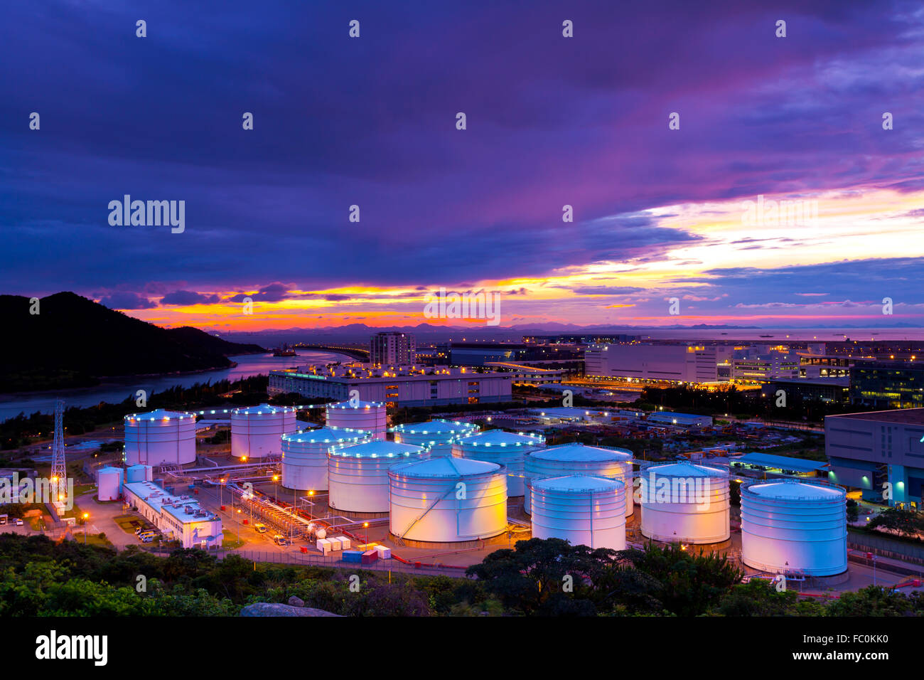 Industrial oil tanks at sunset Stock Photo Alamy