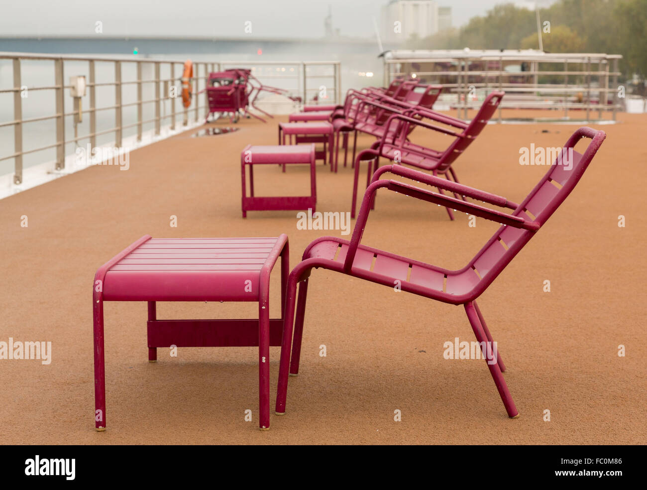 Chairs on deck of river cruise boat in rain Stock Photo