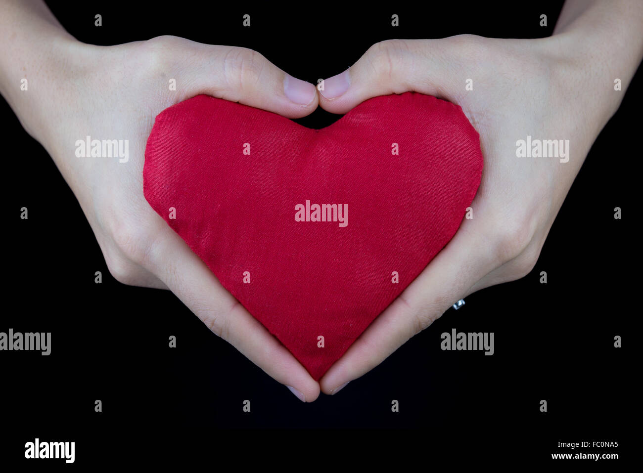 red heart in hands with heart gesture, valentine's concept Stock Photo