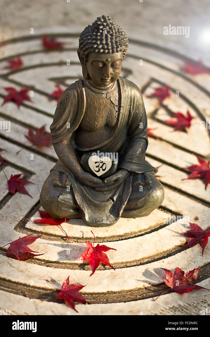 Buddha statue with Om Sign in a heart Stock Photo
