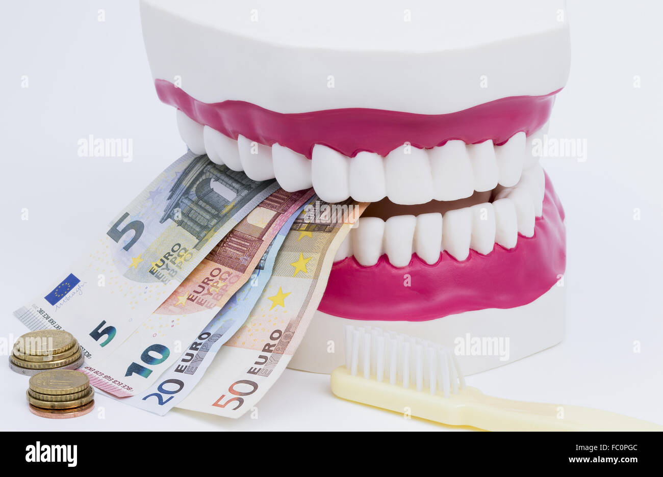 Tooth model with money Stock Photo
