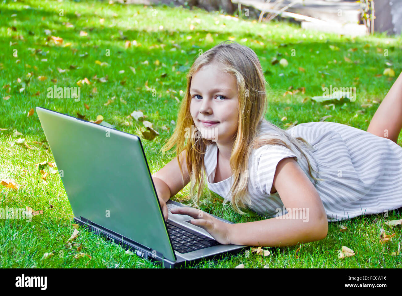 Cute girl with laptop Stock Photo - Alamy