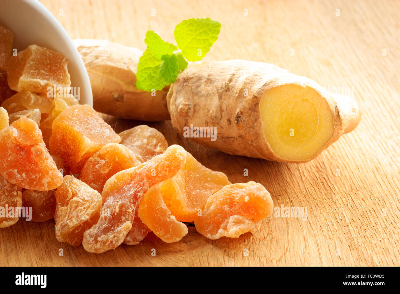 Closeup root and candied ginger on wooden table Stock Photo